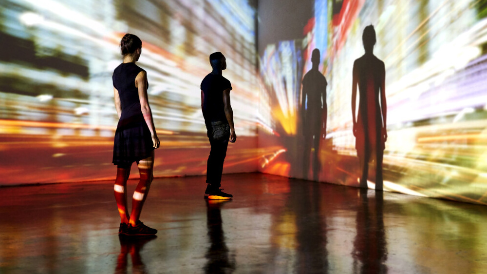 Two people stood in front of projections