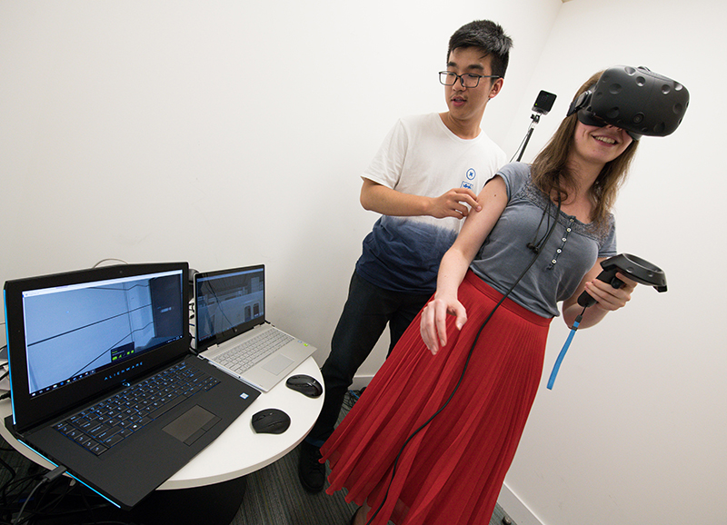 Two people participate in a virtual reality experiment at The Alan Turing Institute. Photo by Arif Gardner.