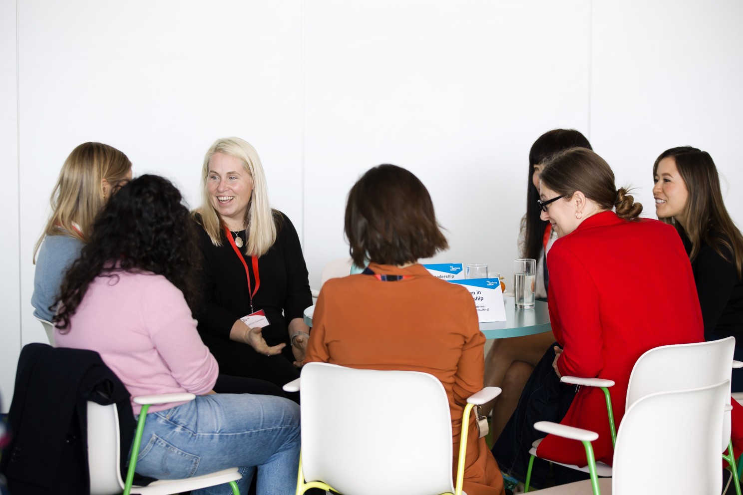 Seven women sitting around a table at the event