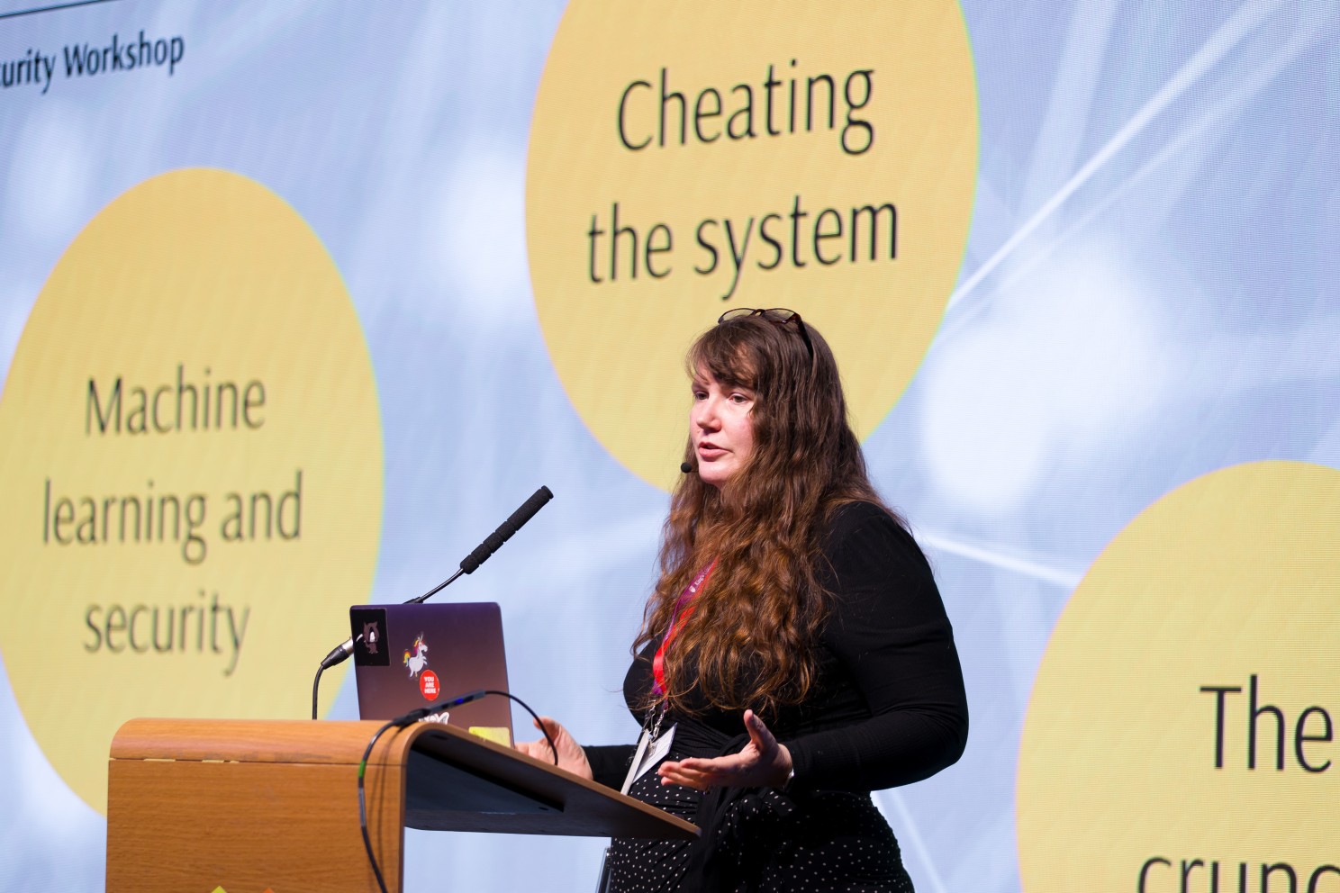 A woman presenting at a Women in AI Security event