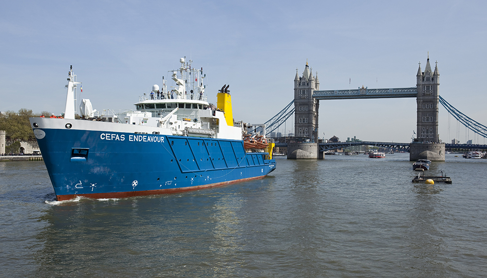 The Cefas Endeavour research vessel navigating the Thames in London, Tower Bridge in the background 