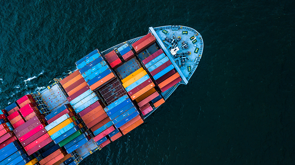 Aerial view of a cargo ship stacked with colourful containers