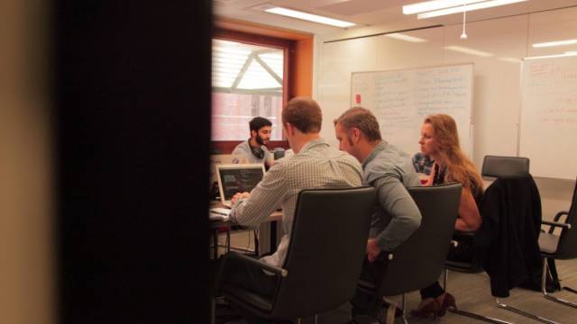 researchers working together at a board room table