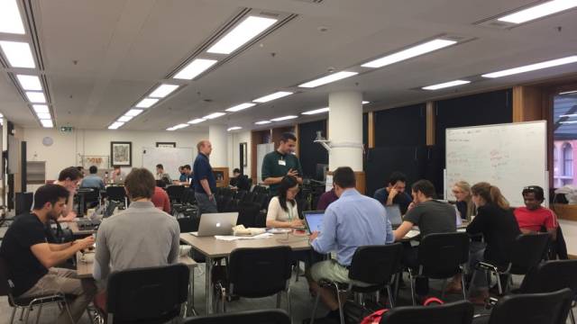researchers working together at a board room table