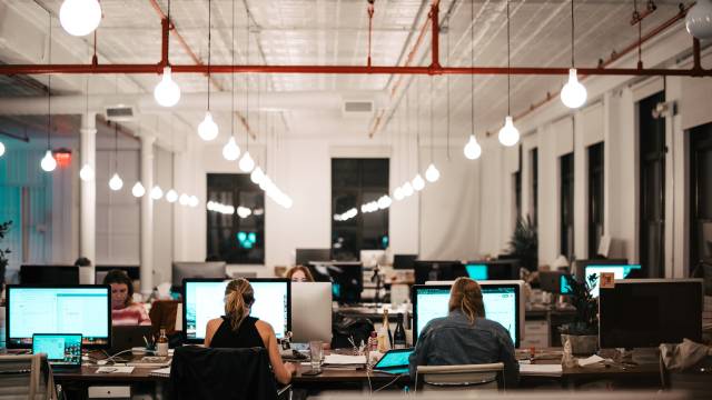 People sitting in front of computers in a modern office