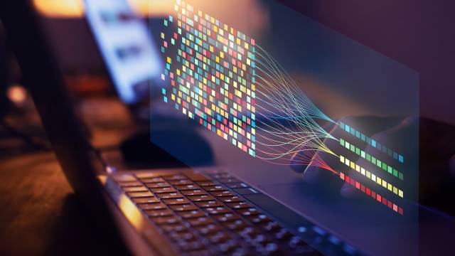 Laptop with colourful data analysis on its screen