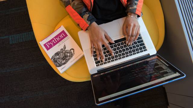 Woman programming on a laptop