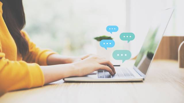 Woman using a chatbot on a laptop