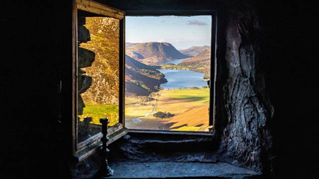 Open window looking out onto picturesque mountainscape