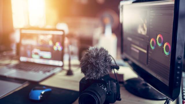 Freelance desk and laptop for editing footage is job for content upload to internet.
