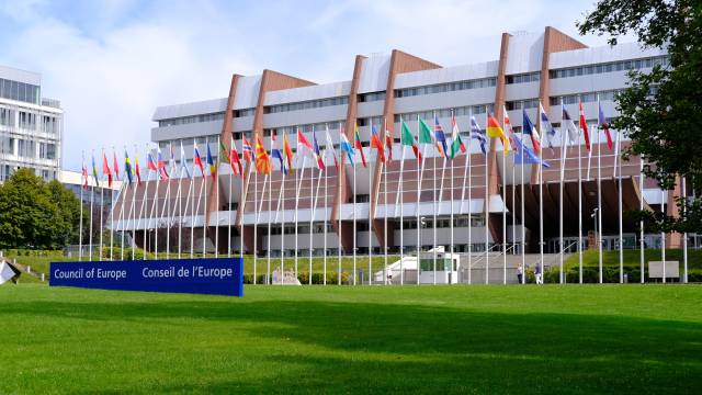Strassbourg, France, August 2021: many national flags in front of building of international organization Council of Europe, concept of standards of law, human rights and cultural interaction