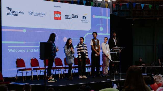 Dr Mhairi Aitken on stage with delegates at the children's AI summit 